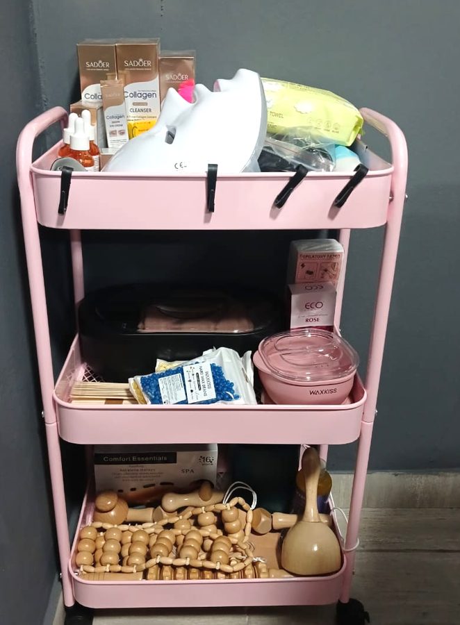 Body care trolley with wax, collagen products and wooden massage tools