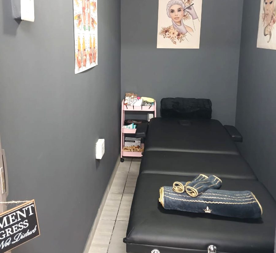 Treatment room with massage bed and towels